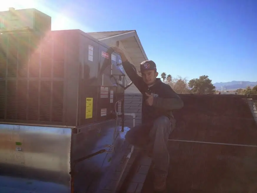 HVAC technician performing HVAC Inspection on a rooftop unit in Indian Trail